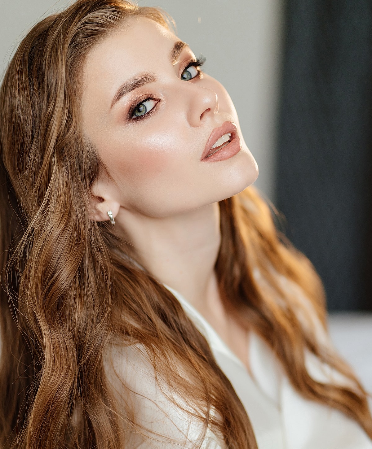 Woman with long hair and elegant makeup.