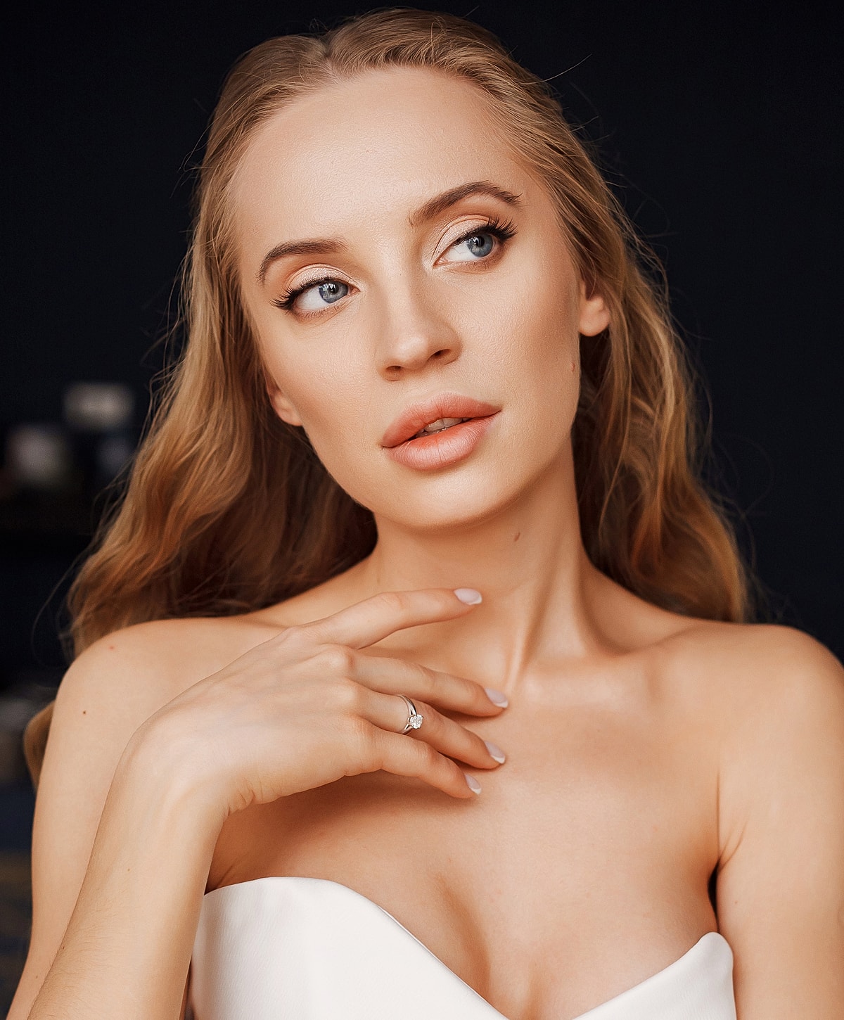 Woman with long hair and elegant makeup.