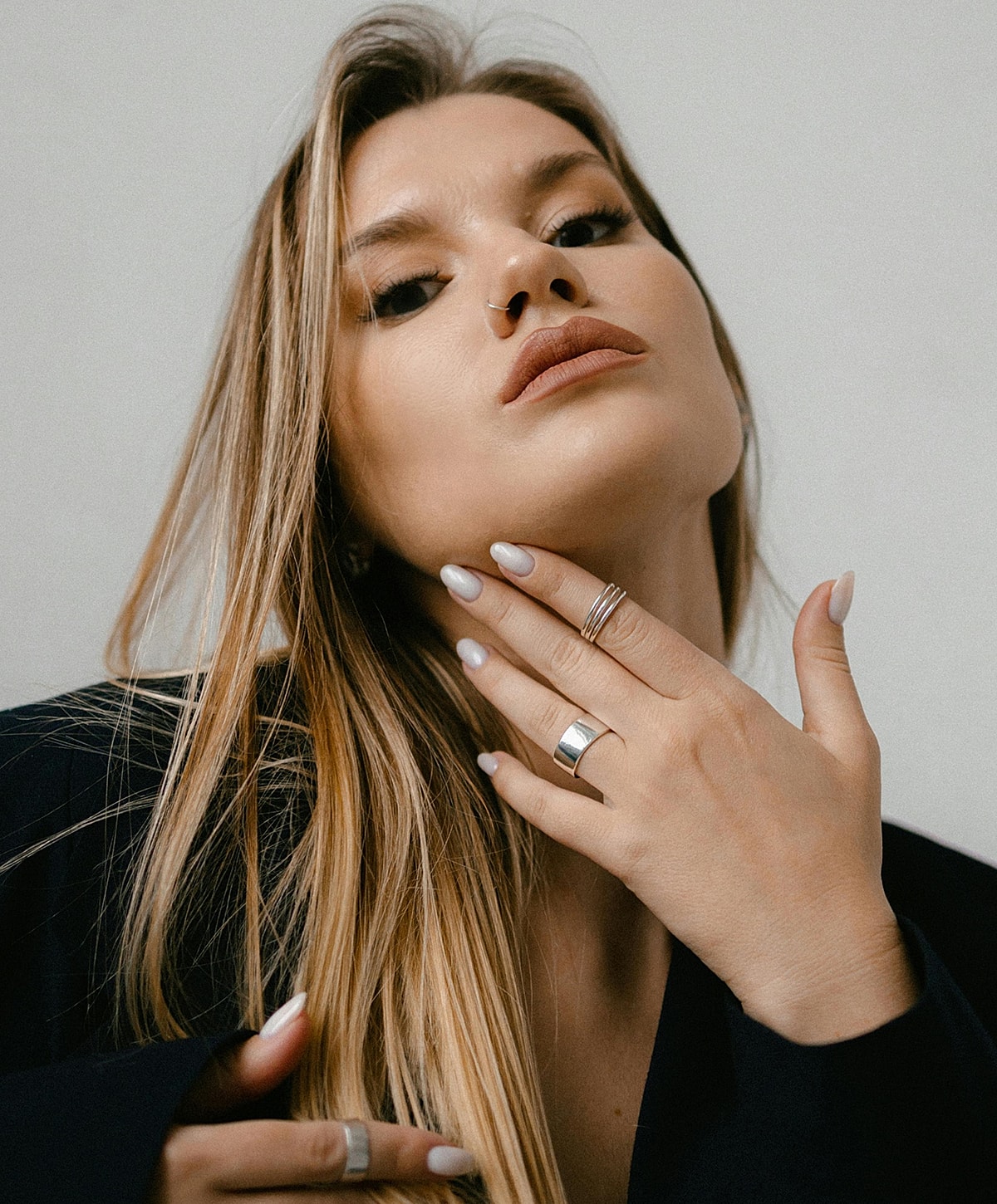 Model showcasing jewelry with stylish pose.