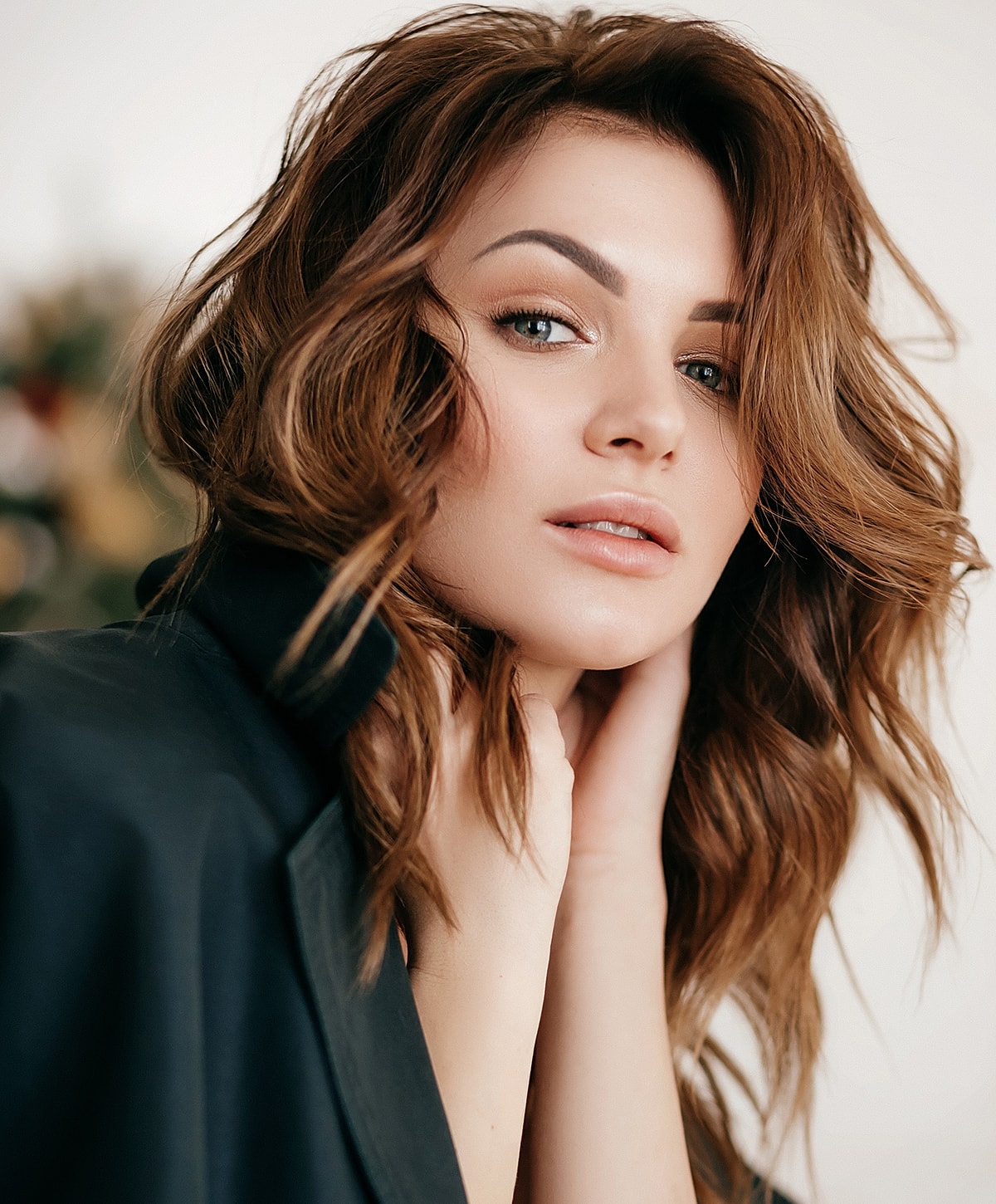 Woman with wavy hair posing gracefully.