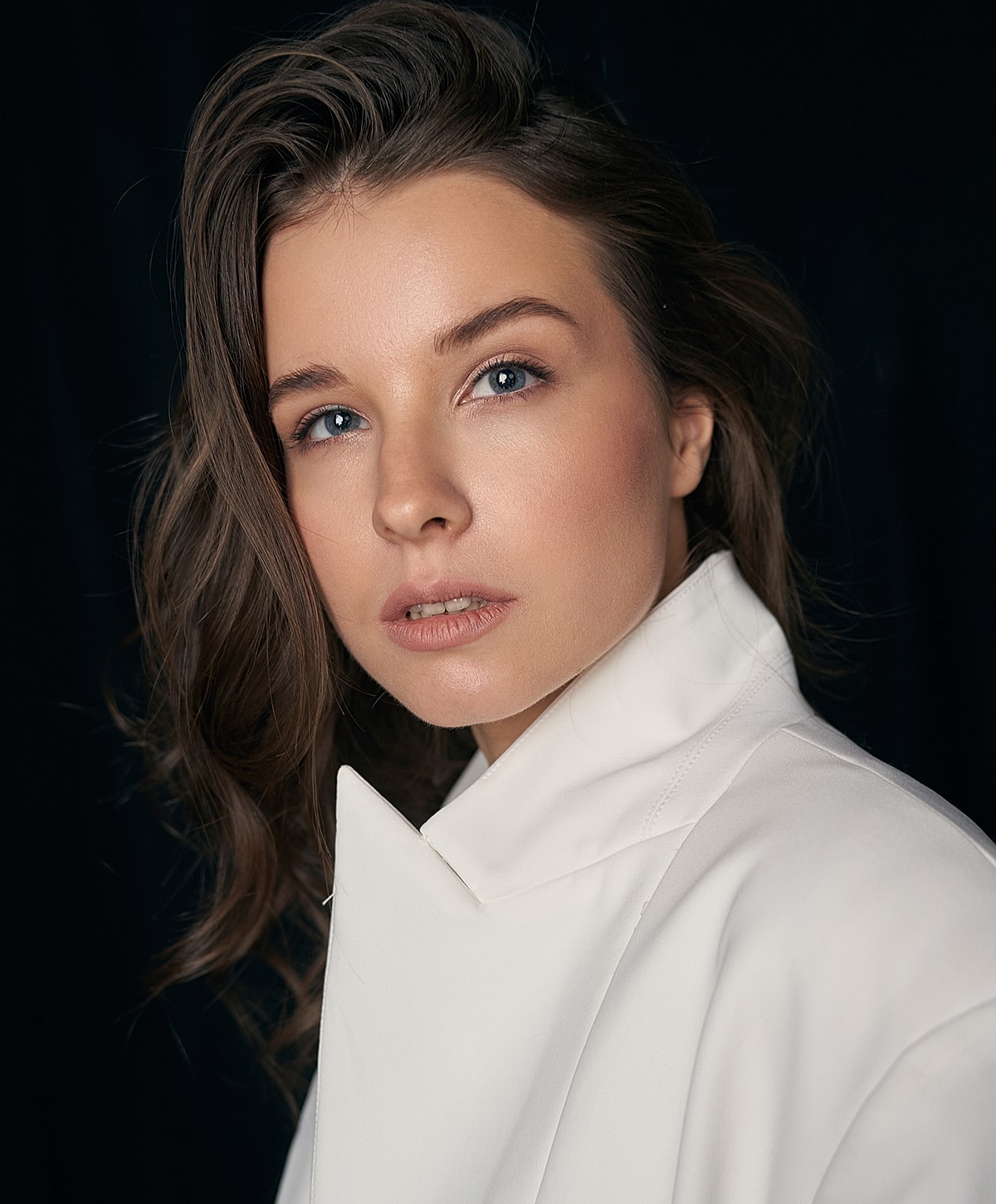Portrait of a woman in a white coat.