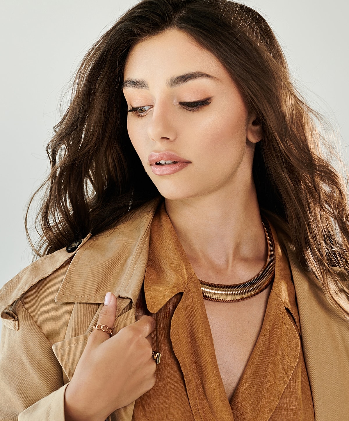 Woman in fashion outfit with jewelry accessories.