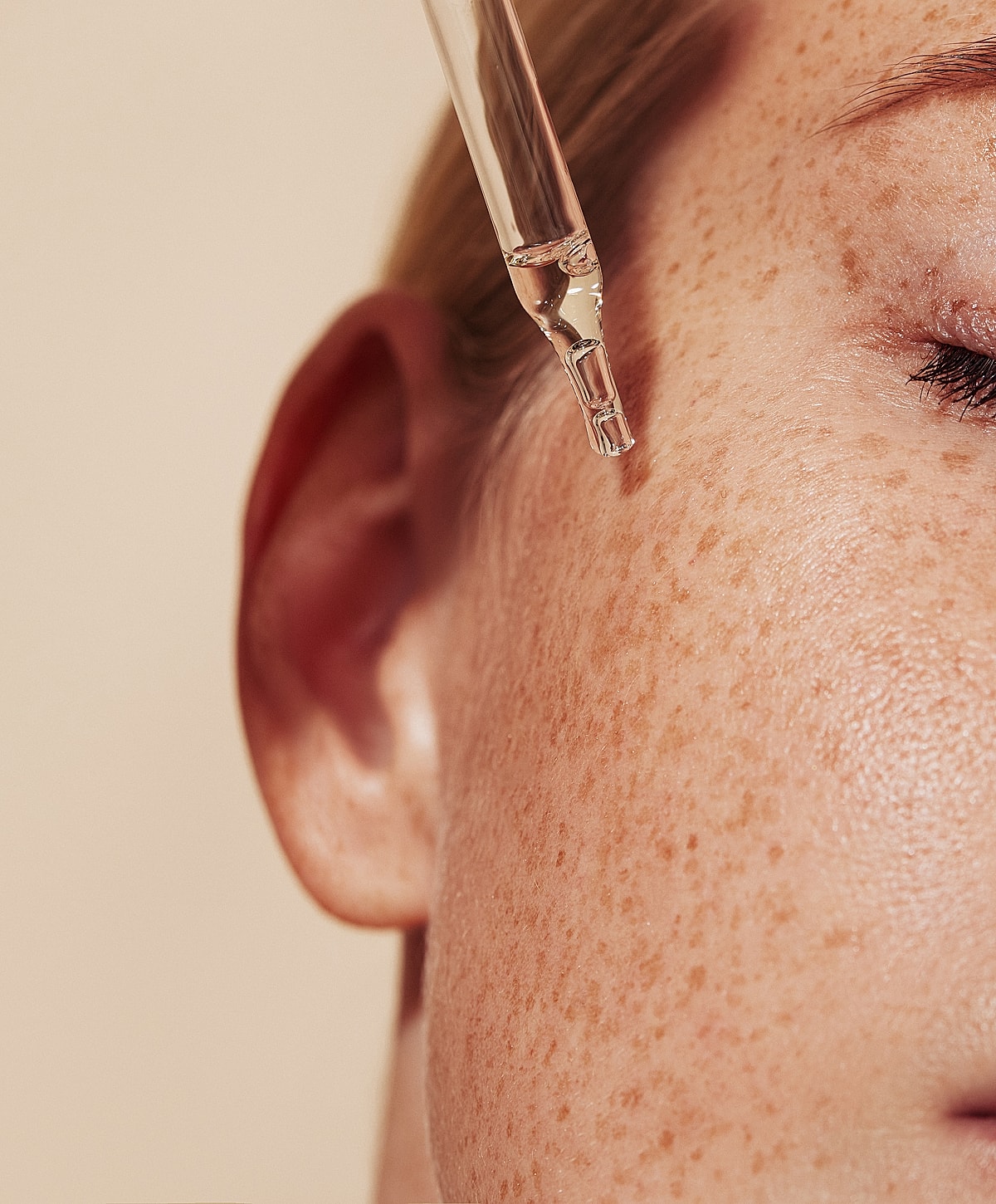 Applying serum to skin with dropper.