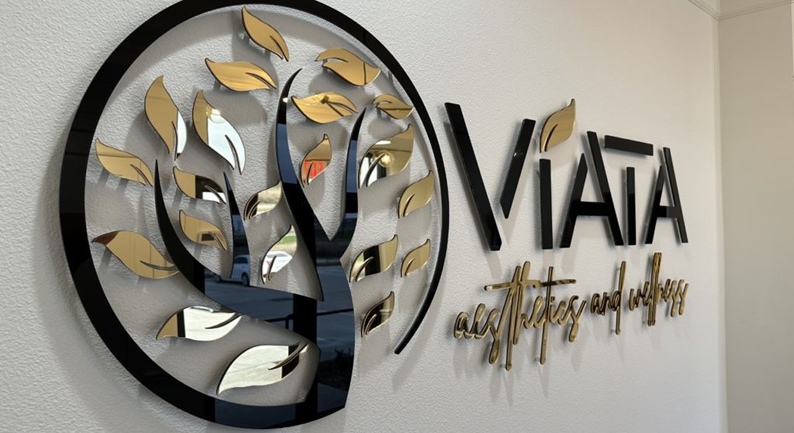 Viata aesthetics and wellness logo on wall.