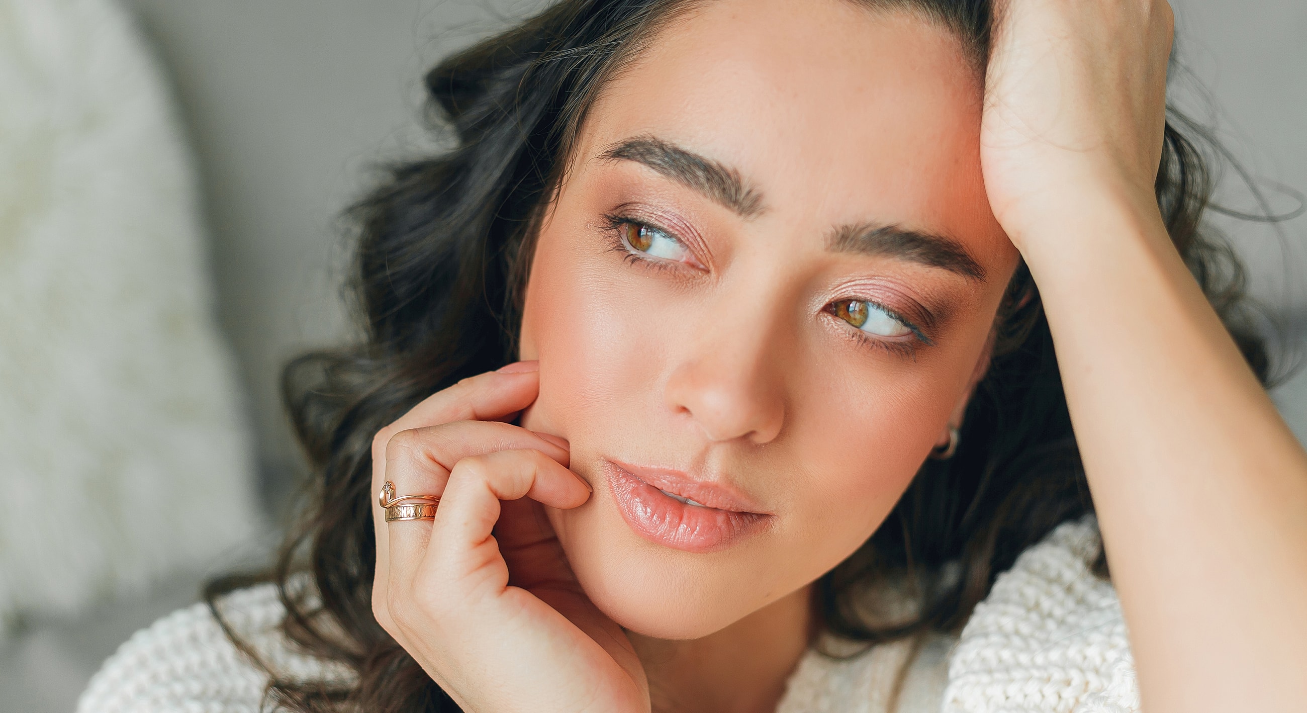 Close-up of woman touching her face thoughtfully